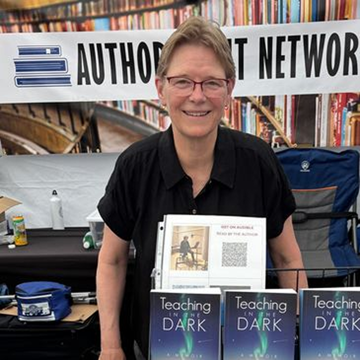 Person promoting books at a booth