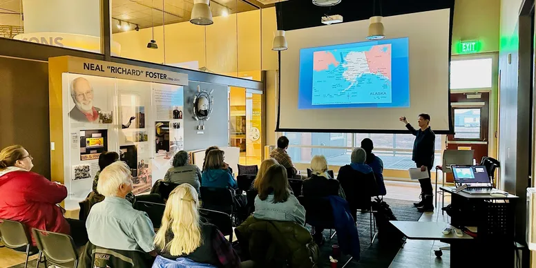People attending a presentation in a museum
